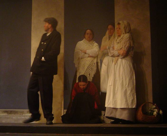 bystanders sheltering from the rain